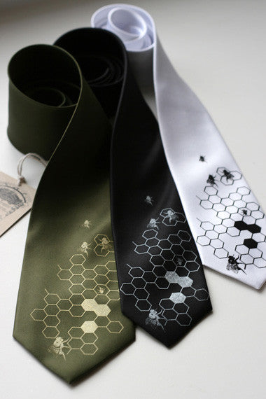 Gold on olive standard, silver on black narrow, black on white narrow.