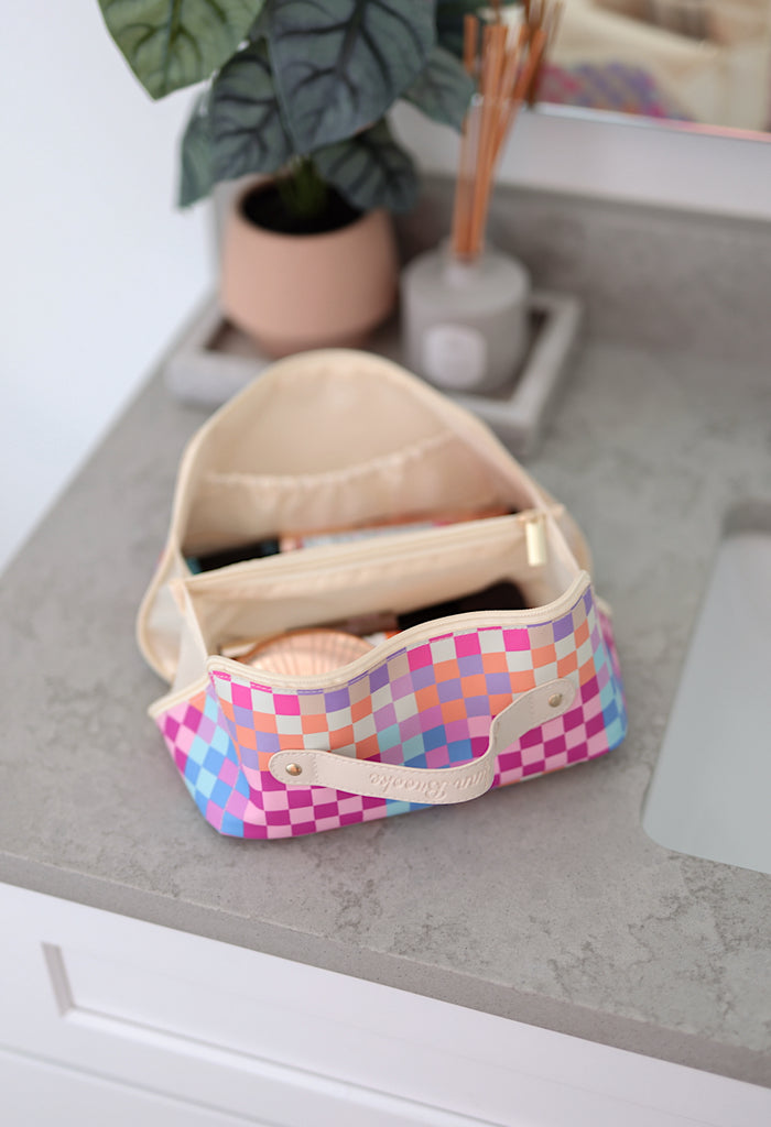 Colorful checkered makeup bag with compartments, pink and blue design, perfect for organizing cosmetics.