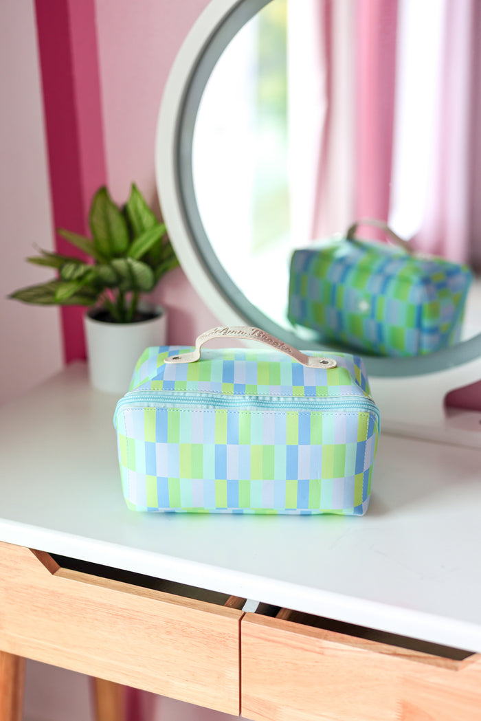 Colorful checkered cosmetic bag in green and blue, made from durable material with a convenient handle.