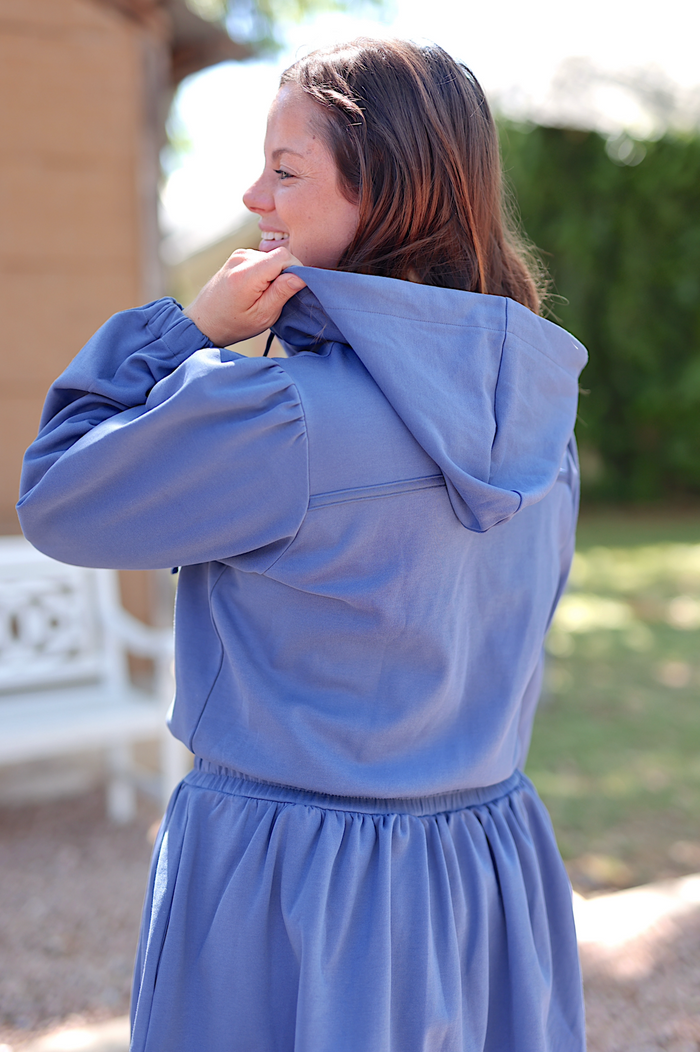 Women's blue hooded dress with puff sleeves, made from lightweight fabric, perfect for casual outings.