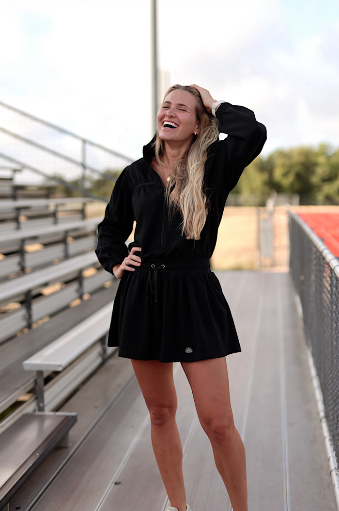 Black zip-up dress with a drawstring waist, perfect for casual outings and sporty activities.