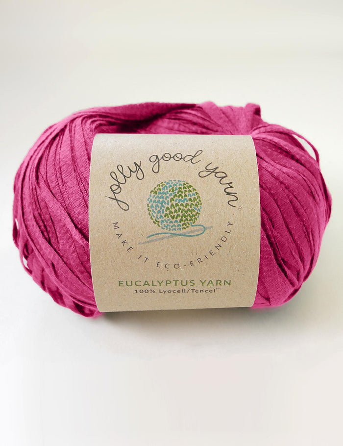 Pink yarn ball with a label on a white background