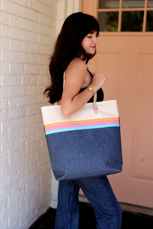 Stylish denim tote bag with colorful straps, perfect for everyday use.