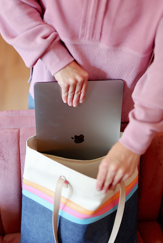 Stylish tote bag with colorful stripes, perfect for carrying a laptop, made of durable canvas.