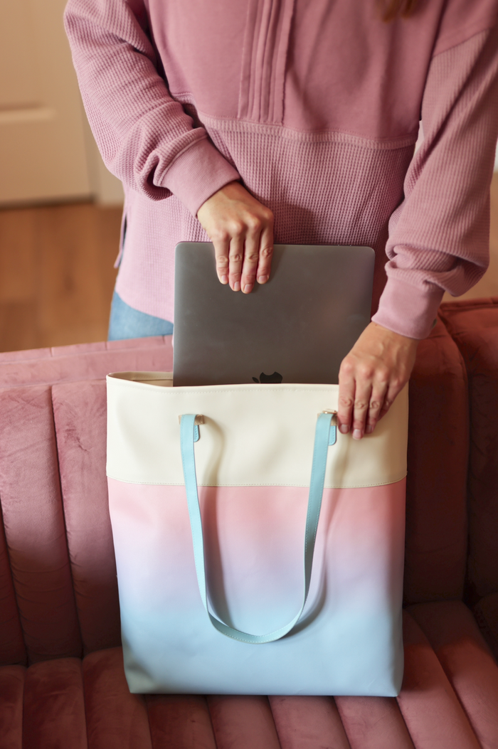 Light pastel gradient tote bag with laptop, featuring dual top handles and a trendy design.