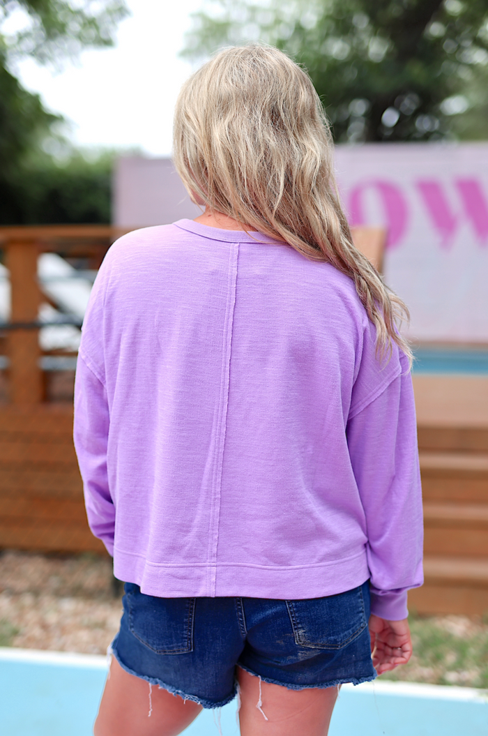 Lavender long-sleeve top, soft fabric, relaxed fit, perfect for casual summer outings.