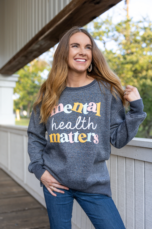 Gray sweatshirt with 'mental health matters' typography, perfect for casual wear and promoting mental wellness.