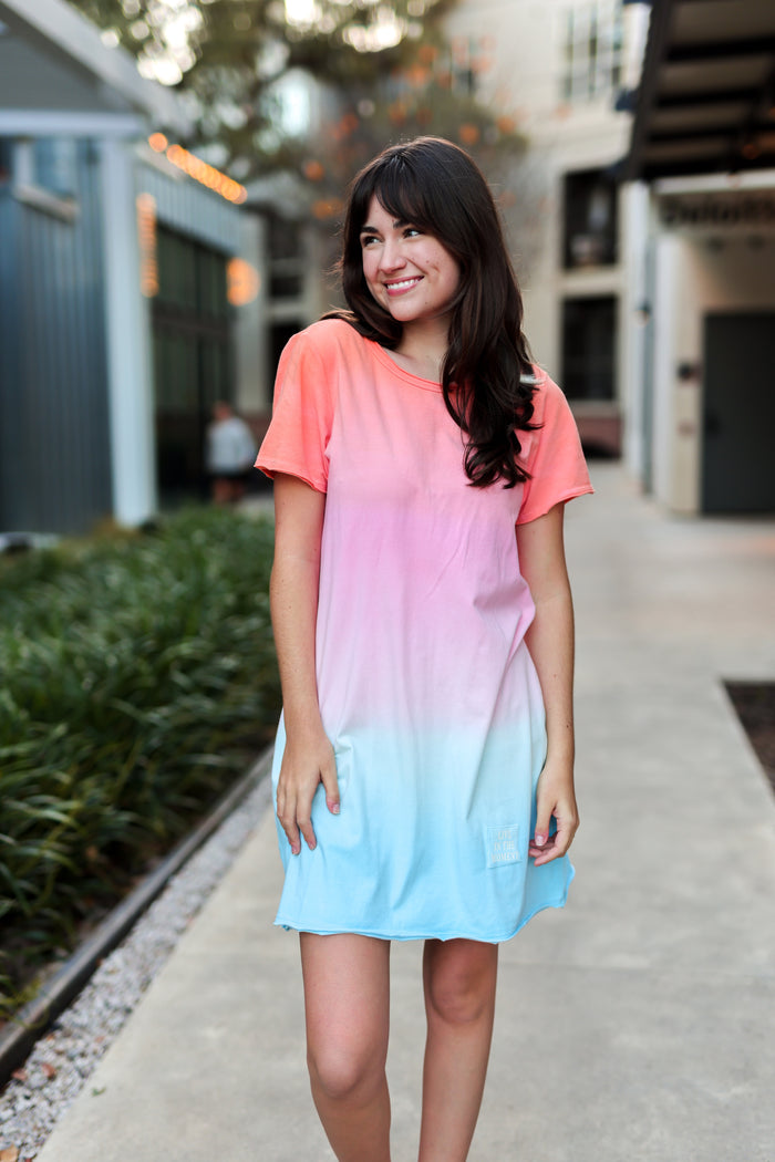 Women's short-sleeve ombre dress in pink and blue, lightweight material for casual summer wear.