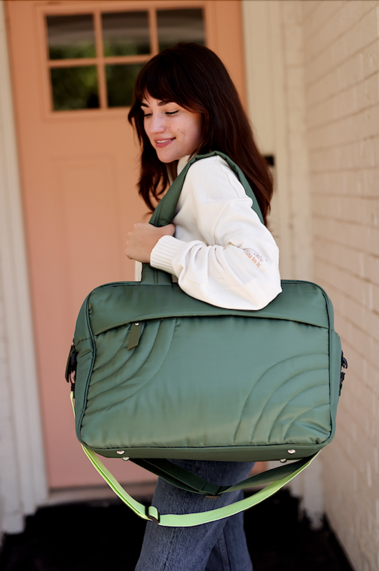 Stylish green quilted laptop bag with adjustable strap and modern design, perfect for daily use.