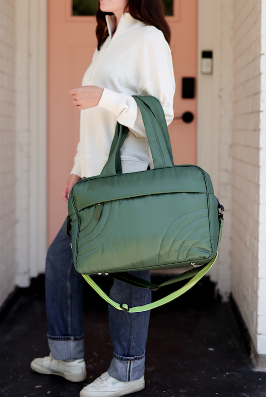 Green quilted laptop bag with detachable strap, spacious for work or travel, stylish and functional.