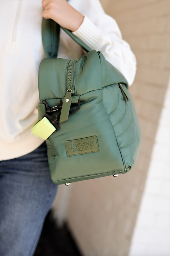 Stylish green puffer handbag by Jadelynn Brooke with adjustable strap and zipper closure.