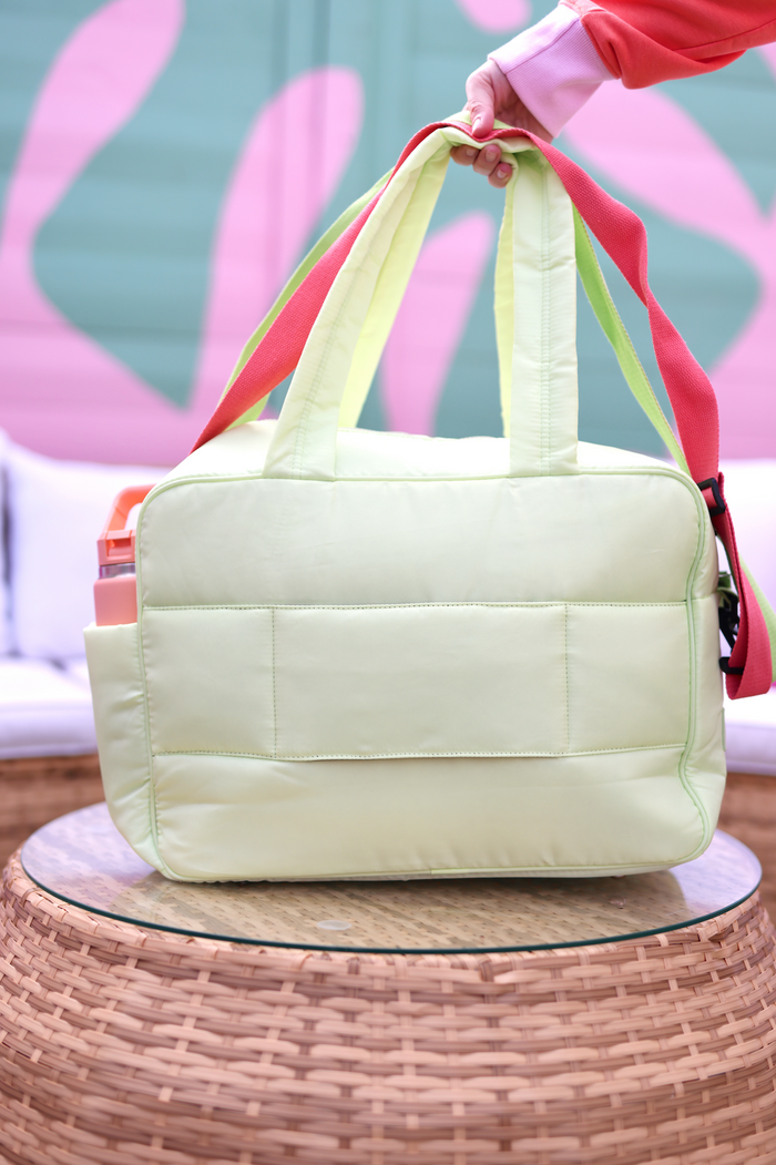 Light green quilted tote bag with colorful straps, perfect for everyday use and stylish outings.