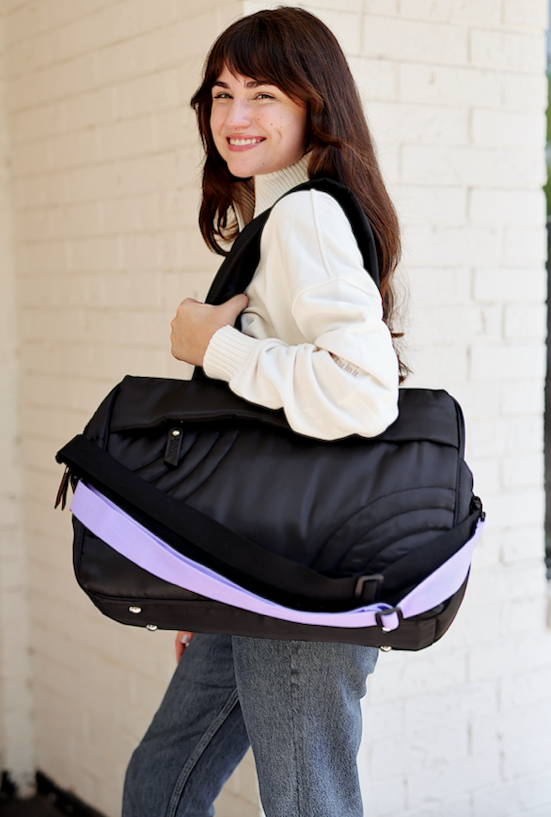 Black spacious travel bag with purple strap, made of durable material, perfect for everyday use.