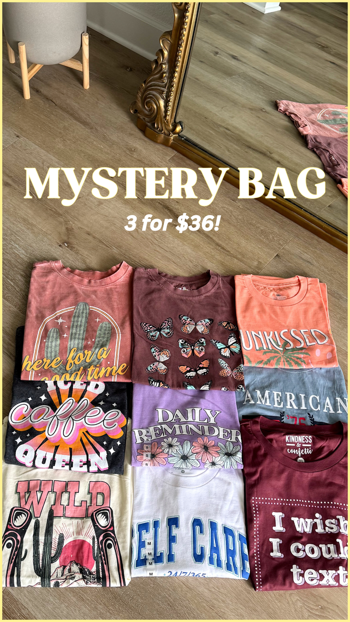 Mystery bag of assorted graphic t-shirts in various colors and designs, 3 for $36.