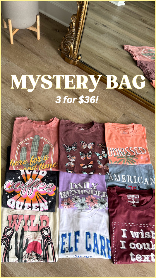 Mystery bag of assorted graphic t-shirts in various colors and designs, 3 for $36.