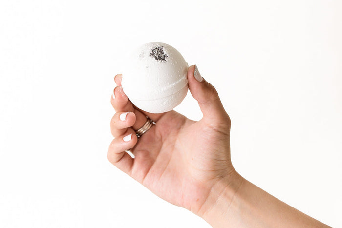 Natural Bath Bomb Gift Set - Woman's hand holding natural bath bomb from set | Lizush