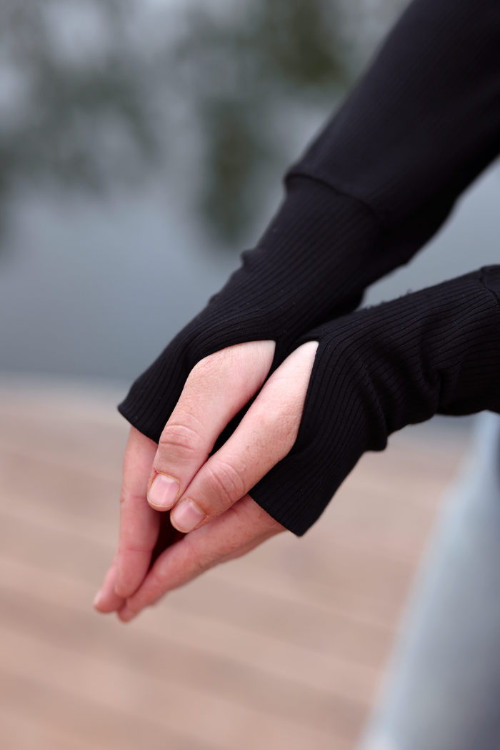Black ribbed thumbhole sleeves, perfect for layering and added warmth in cooler weather.
