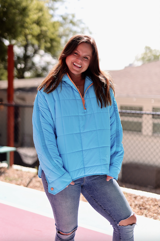 Light blue quilted pullover jacket with half-zip and cozy fit, perfect for casual wear.