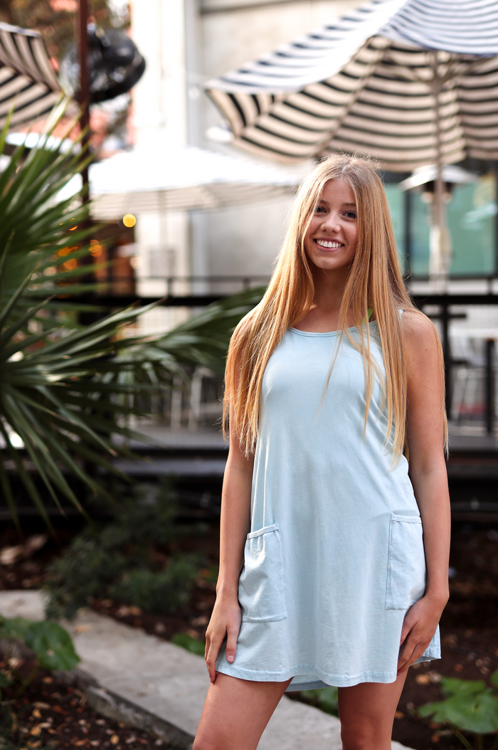 Light blue sleeveless dress with pockets, made from soft cotton, perfect for casual summer outings.