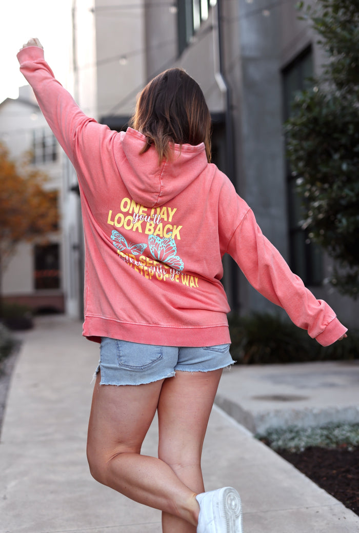 Coral hoodie with butterfly graphic, features 'One Day You'll Look Back', casual style.