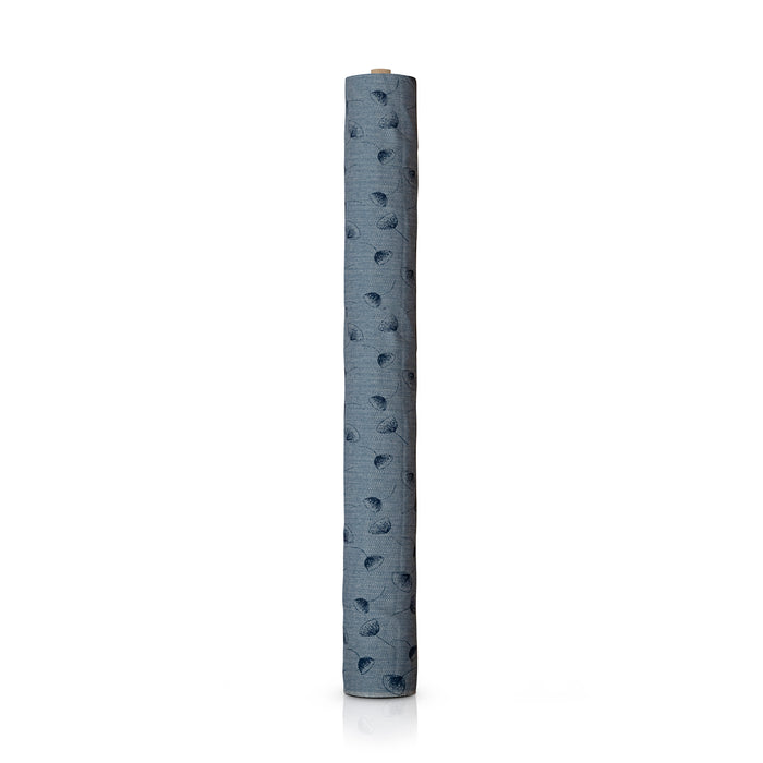 A single rolled piece of textured fabric, in a dusty slate blue colour with a repeating dark blue flower pattern, standing vertically on a white background.