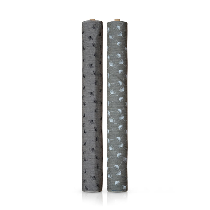 Two grey fabric rolls standing upright on a white background, one with a black flower pattern and the other with a white flower pattern.