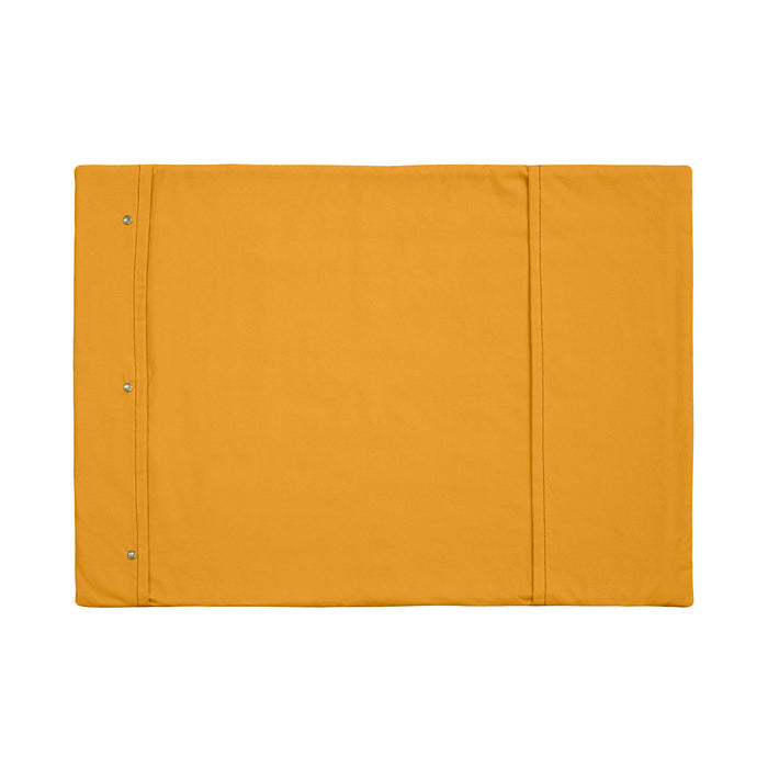 A Chimney Sheep wool filled portable rollup travel dog bed sits on a white background. This flat rectangular portable roll up dog bed is in the colour yellow. You can see the white poppers which allow it to be simply rolled into a tight package for easy transportation.