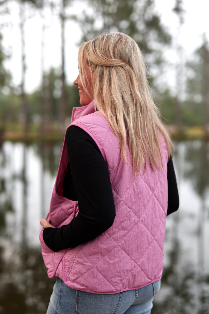 Women's pink quilted vest made of lightweight material, perfect for layering in chilly weather.