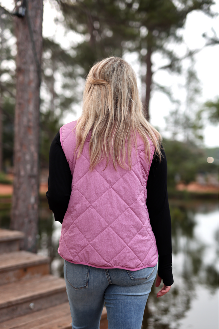 Women's pink quilted vest, perfect for layering, stylish and lightweight for cooler days.