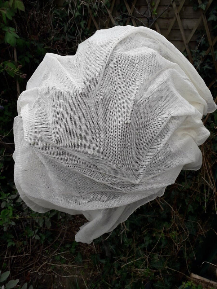 Bio-certified netting tightly wrapped around garden plants.