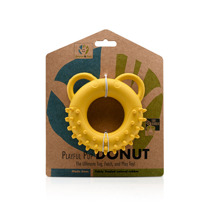 Yellow Fairtrade rubber dog toy doughnut in a brown packaging with branding on a white background