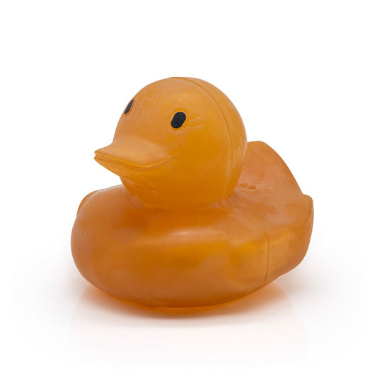 Natural latex rubber yellowish coloured duck with a pensive smile on a white background