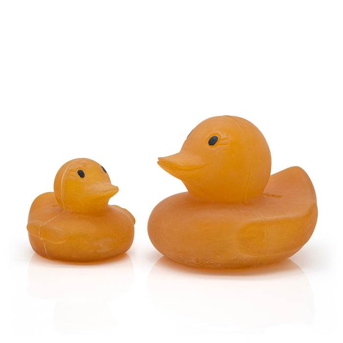 Large and small natural coloured rubber ducks facing each other.