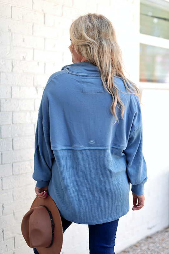 Cozy blue oversized pullover, featuring a textured design and long sleeves, perfect for casual wear.