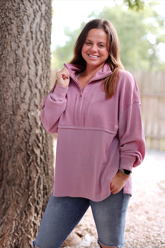 Cozy pink quarter-zip pullover, soft waffle knit material, perfect for casual outings and everyday wear.