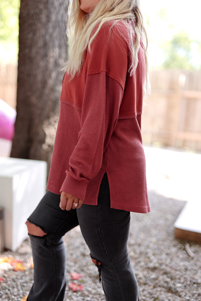Women's maroon waffle knit top with side slits, perfect for casual wear and layering.