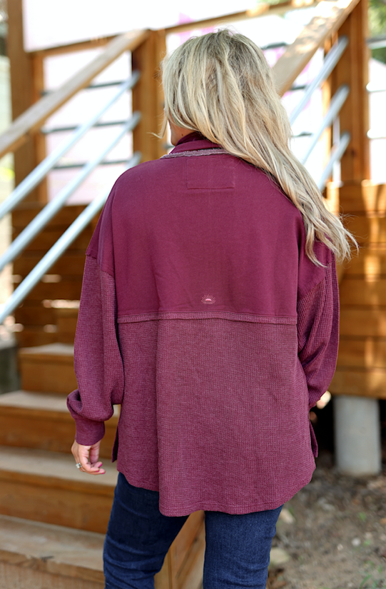 Back view of a burgundy lightweight shirt, featuring a relaxed fit and textured fabric.