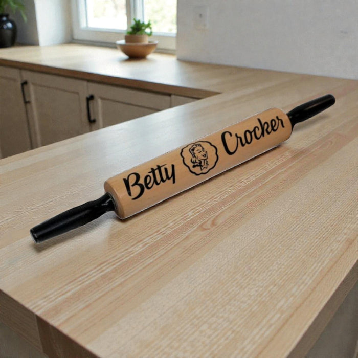 Wooden rolling pin with 'Betty Crocker' branding on a kitchen counter.