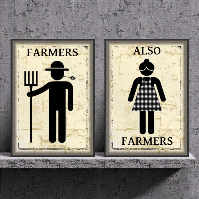 Two framed posters on a shelf with illustrations of a farmer and a woman labeled 'Farmers Also Farmers' against a textured wall.