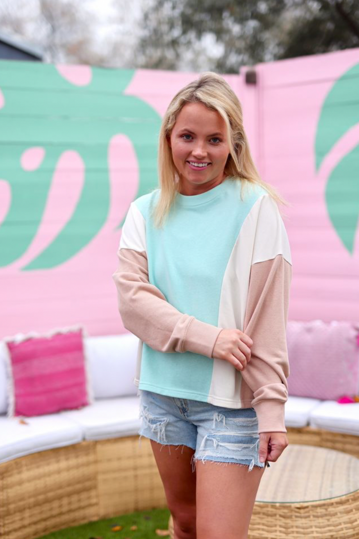 Stylish women's color-blocked sweatshirt in mint, beige, and cream; perfect for casual outings.