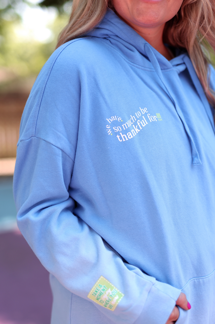 Light blue hoodie with grateful message, soft cotton fabric, perfect for casual wear.