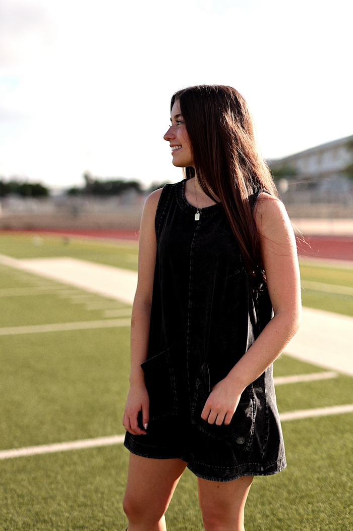 Black denim sleeveless dress with pockets, perfect for casual outings and warm weather.