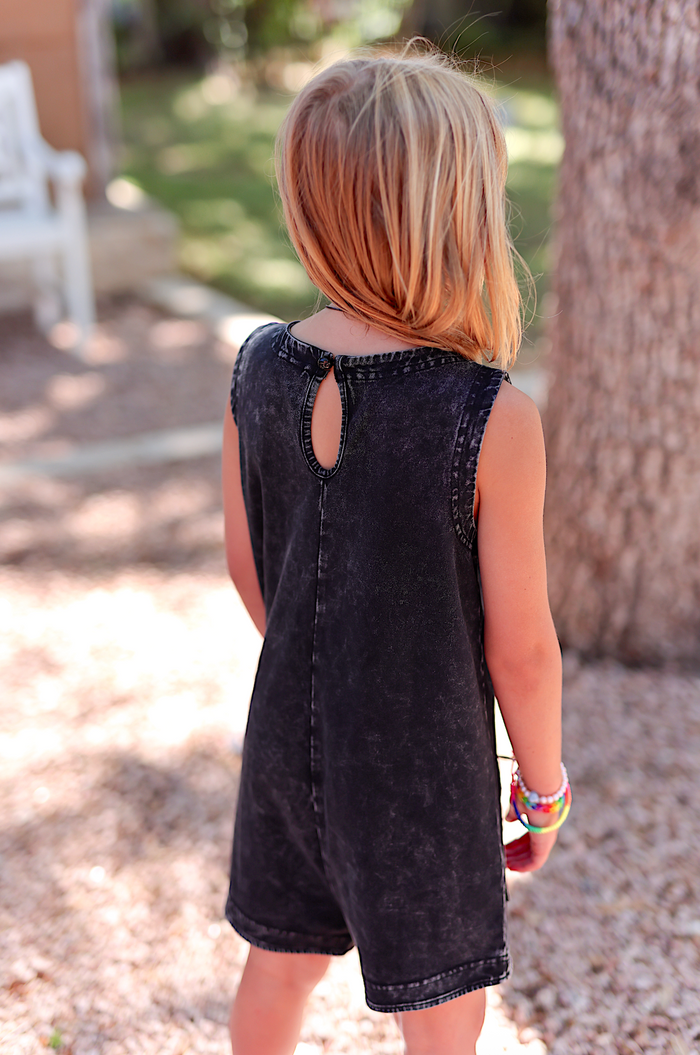 Black denim romper for kids with a keyhole back detail, perfect for summer wear.