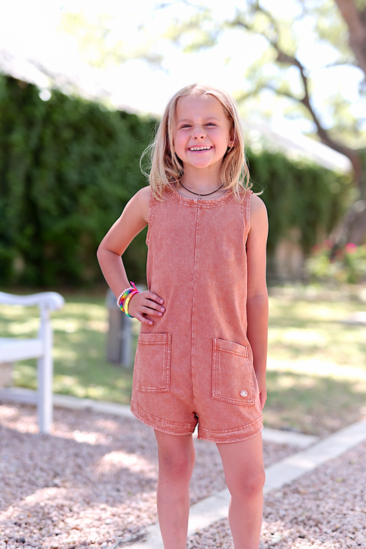 Girls' rust orange denim romper featuring front pockets and a summer casual style.