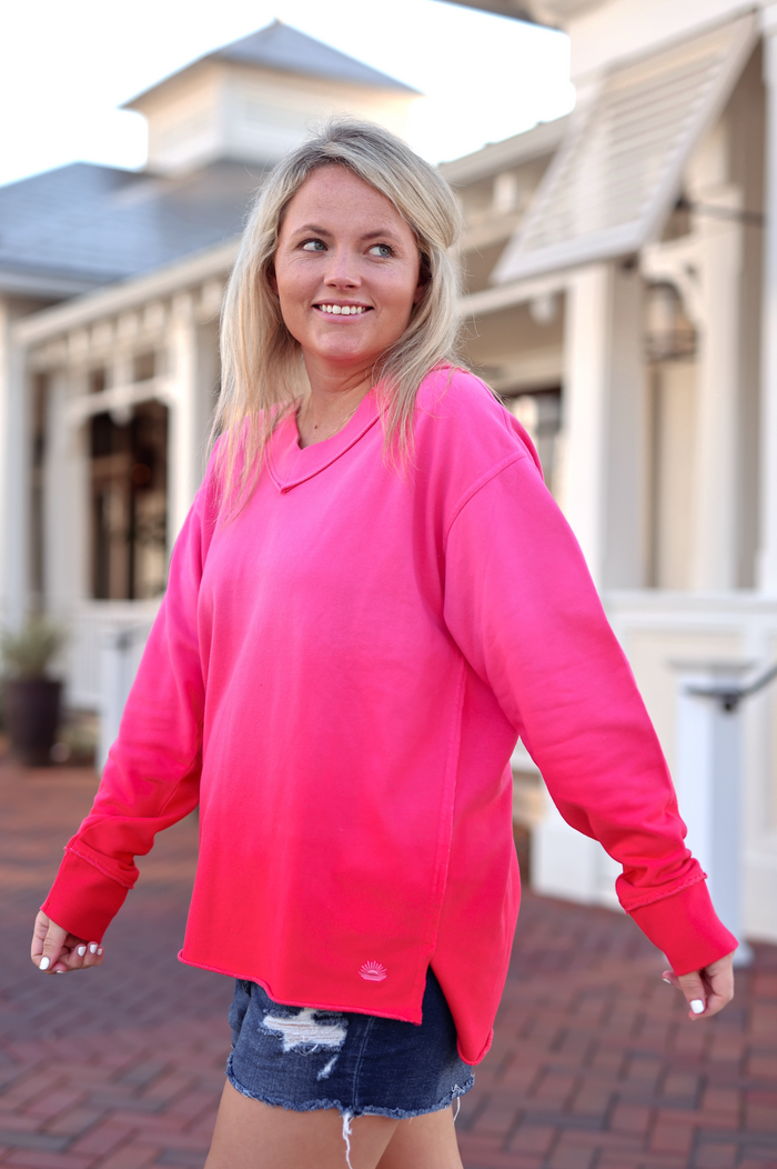 Vibrant pink pullover sweatshirt, relaxed fit, cotton material, perfect for casual outings.
