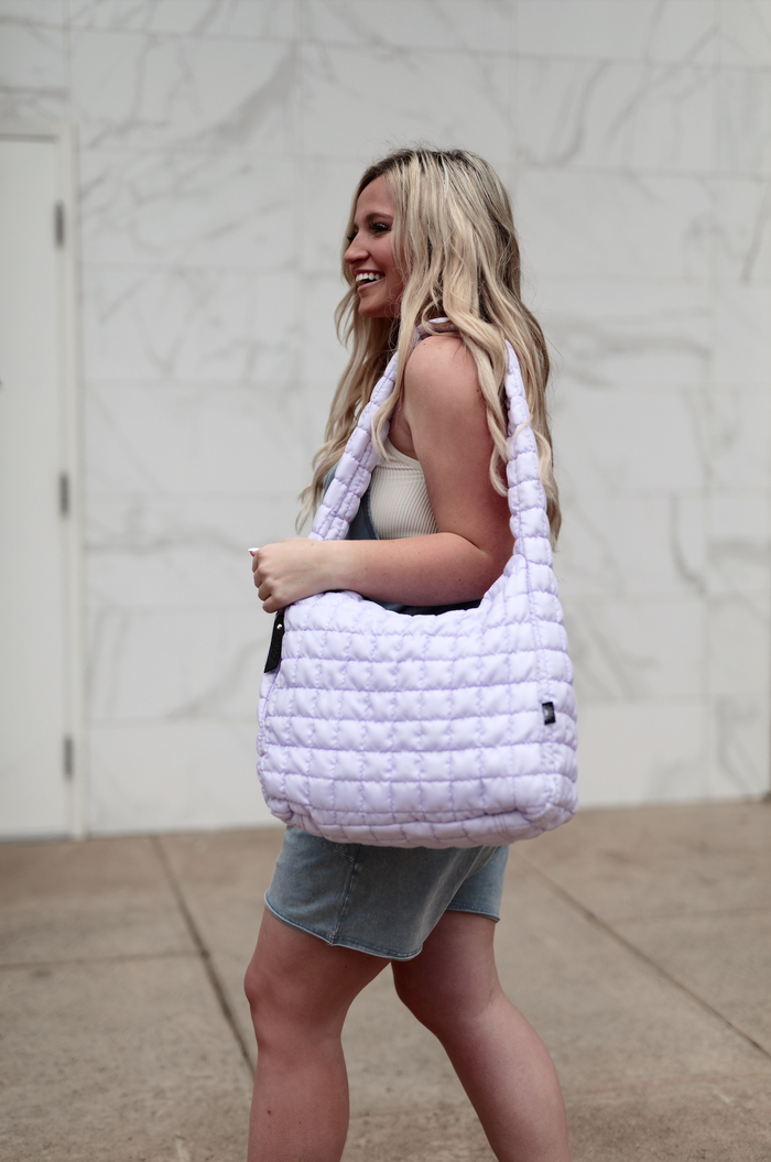 Light purple quilted shoulder bag, perfect for casual outings, made from soft, durable material.