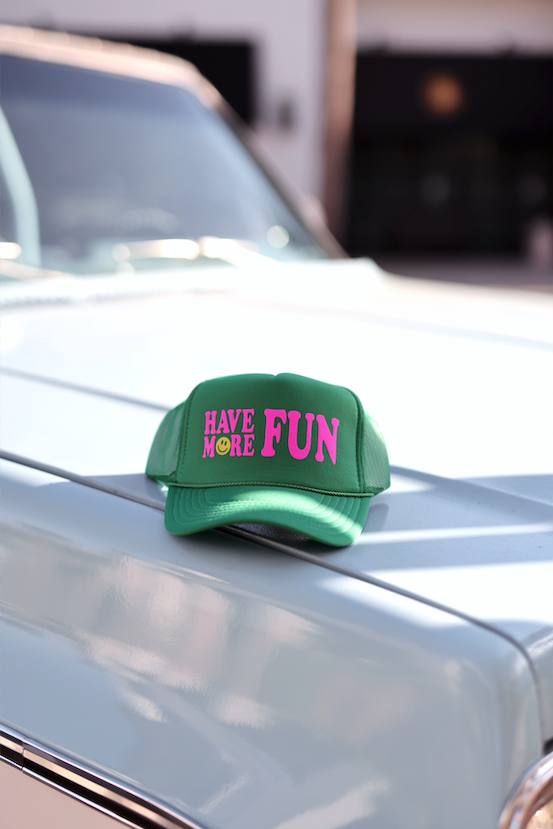 Green snapback cap with 'HAVE MORE FUN' text in pink and yellow, perfect for casual summer outings.