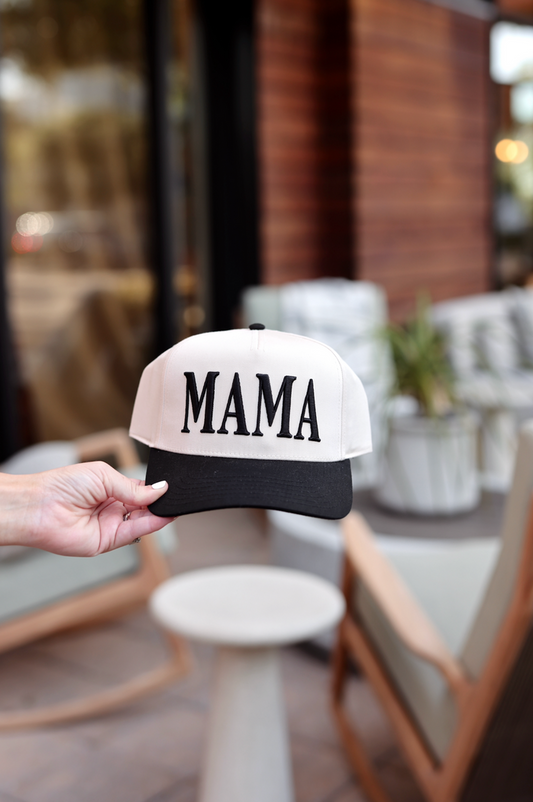 White and black MAMA cap, stylish adjustable baseball hat for casual wear.