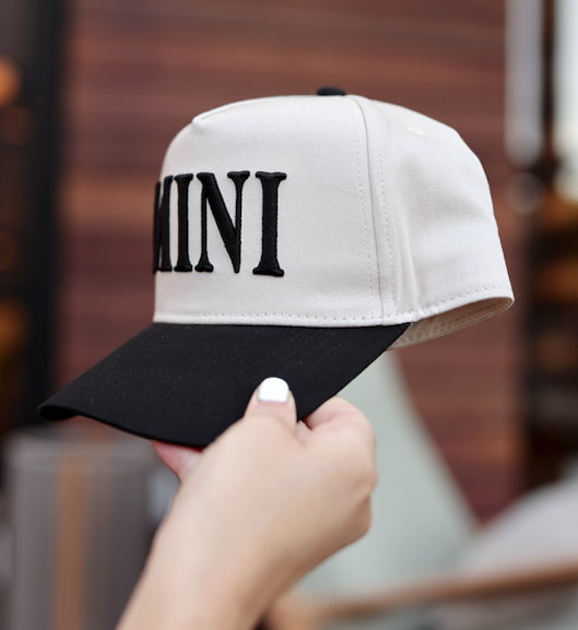 Beige and black cap with 'MINI' embroidered on the front, perfect for casual wear.