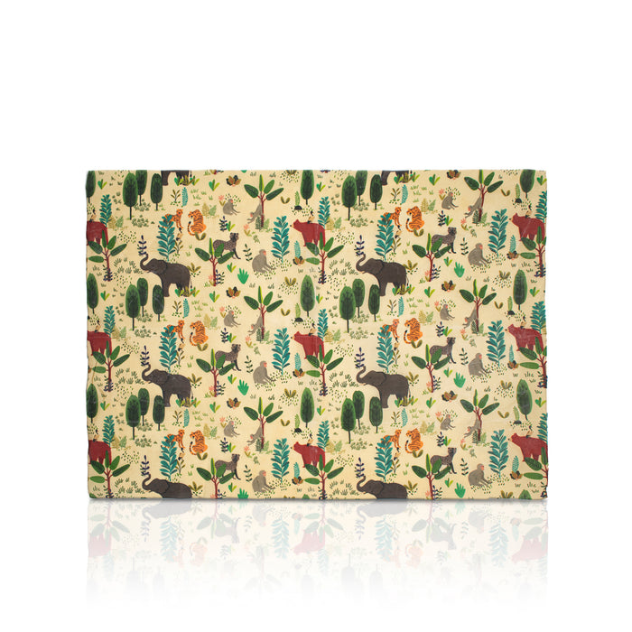A rectangular beeswax wrap, featuring a whimsical woodland safari pattern with animals like elephants, giraffes, lions, and zebras on a light beige background. The wrap is displayed flat against a white background with a soft reflection underneath.